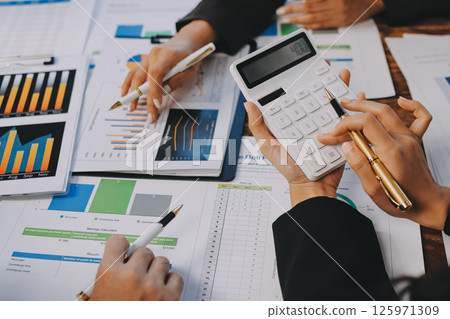 Business financing accounting banking concept. Business woman hand doing finances and calculate on desk about cost at home office. Woman working on desk with using calculator, finance accounting. 125971309