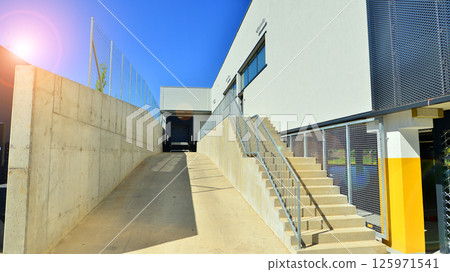 Modern office building with concrete facade and windows. Modern architectural details. 125971541