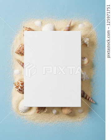 Rectangular white canvas lies on a sandy surface surrounded by white and brown shells on a pastel blue background. Place for your text, advertisement, invitation. Rectangular white canvas lies on a sandy surface surrounded by white and brown shells on a pastel blue background. Place for your text, advertisement, invitation. 125971751