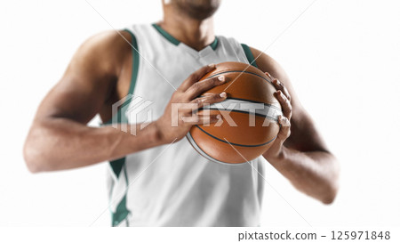 Basketball player holding a ball. Close-up. Focus on the ball. Professional basketball on a white background 125971848