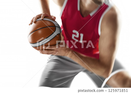 Basketball close-up. Focus on the ball. Professional basketball player preparing to attack. Isolated on a white background 125971851