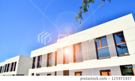 New single family houses in a new development area. Residential homes with modern facade. New single family houses in a new development area. Residential homes with modern facade. 125971937