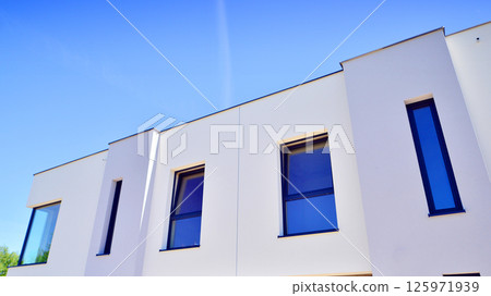 New single family houses in a new development area. Residential homes with modern facade. New single family houses in a new development area. Residential homes with modern facade. 125971939