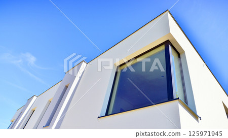 New single family houses in a new development area. Residential homes with modern facade. New single family houses in a new development area. Residential homes with modern facade. 125971945
