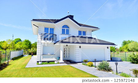 Luxury real estate single family house with white modern facade. A suburban district of single-family homes. Luxury real estate single family house with white modern facade. A suburban district of single-family homes. 125972148