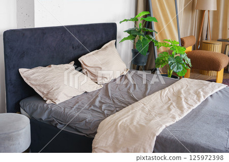 Cozy bedroom setting with pillows and cotton soft on black headboard background Cozy bedroom setting with pillows and cotton soft on black headboard background 125972398