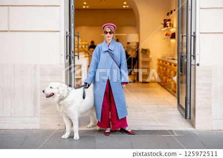 Woman and her dog outside a boutique 125972511