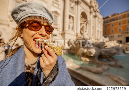 Smiling with a Cannolo by Trevi Fountain Smiling with a Cannolo by Trevi Fountain 125972559