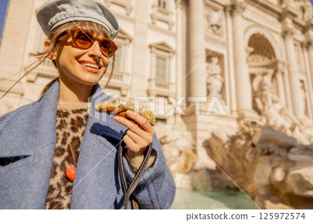 Smiling with a Cannolo by Trevi Fountain Smiling with a Cannolo by Trevi Fountain 125972574