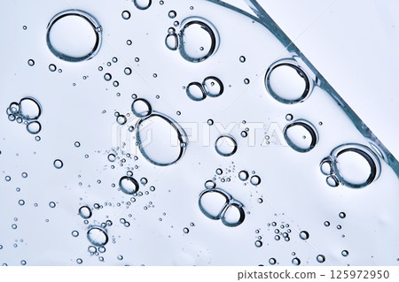 A drop of gel serum with bubbles. The texture. View from below. A drop of gel serum with bubbles. The texture. View from below. 125972950