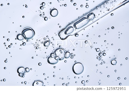 The texture of hyaluronic serum with lots of bubbles with a pipette. The texture of hyaluronic serum with lots of bubbles with a pipette. 125972951