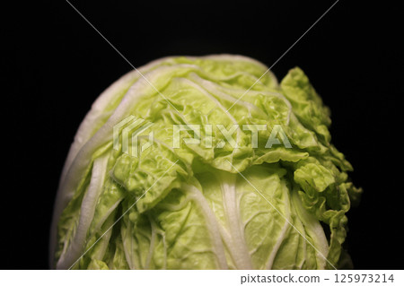 Top Part Of Napa Cabbage Head Isolated On Black Background. Head Of Peking Cabbage Isolated On Black Backdrop Top Part Of Napa Cabbage Head Isolated On Black Background. Head Of Peking Cabbage Isolated On Black Backdrop 125973214