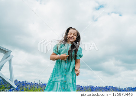 Teenage girl with long hair in lavender. Fun in the lavender field.  125973446