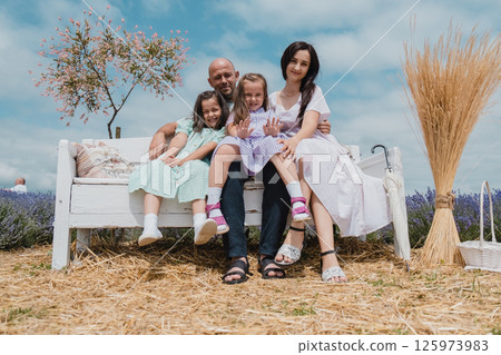 A happy family with many children is vacationing in a picturesque place. A happy family with many children is vacationing in a picturesque place. 125973983