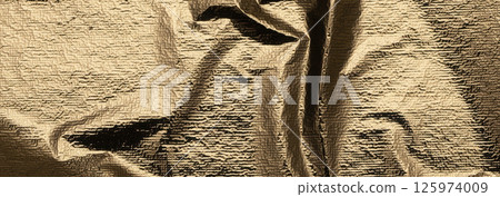 Golden foil surface with a polished, crumpled texture. Elegant, shiny drapery creating a beautiful 125974009