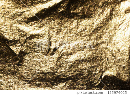 Golden foil with crumpled, metallic texture creates a dramatic, reflective surface. Shiny, embossed Golden foil with crumpled, metallic texture creates a dramatic, reflective surface. Shiny, embossed 125974025