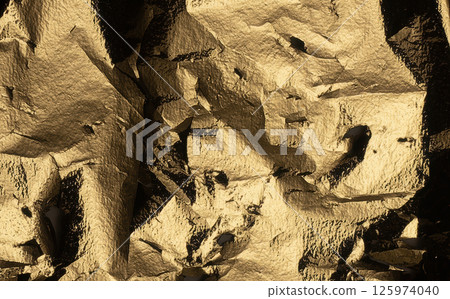 Golden metallic foil texture with torn, crumpled, and jagged edges. Shiny, reflective surface with a 125974040