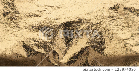 Rich gold foil texture with darkened central creases and contrasting shadows. The visual depth and 125974056