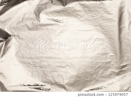 Silver foil crumpled texture with shiny, metallic surface. Smooth, reflective gloss and gradient 125974057