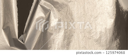Silver foil with shiny, metallic texture creates a smooth, reflective surface. decor, and abstract Silver foil with shiny, metallic texture creates a smooth, reflective surface. decor, and abstract 125974068