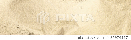 Gold foil texture with a soft, pale background. Smooth, shiny surface with subtle shimmer and Gold foil texture with a soft, pale background. Smooth, shiny surface with subtle shimmer and 125974117