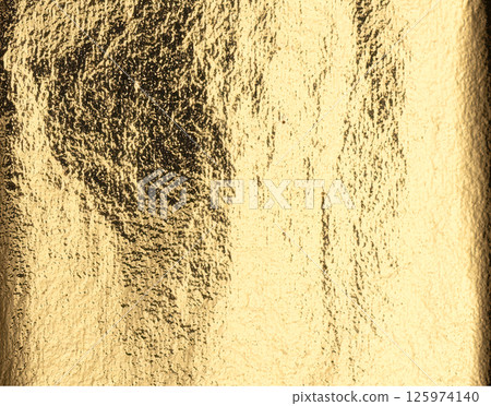 Gold metallic foil background. Shiny golden texture with reflective light, distressed finish, and Gold metallic foil background. Shiny golden texture with reflective light, distressed finish, and 125974140