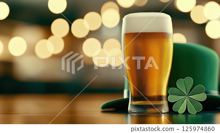 Freshly poured beer, green leprechaun hat and shamrock on bar counter 125974860