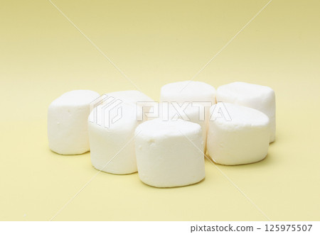Marshmallows on a yellow background Marshmallows on a yellow background 125975507