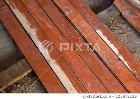 Old wooden planks. Replacement of the wooden floor in the living room, repair work Old wooden planks. Replacement of the wooden floor in the living room, repair work 125978189