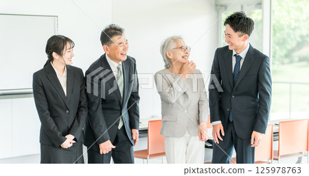 Elderly people and young people in suits (seminars, training, education, study groups, generational change, management) Elderly people and young people in suits (seminars, training, education, study groups, generational change, management) 125978763