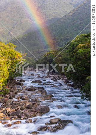 A beautiful rainbow over the Yakushima Offshore Alps (August) 125978851