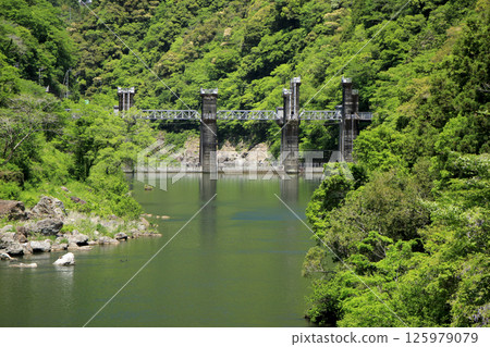 Dam lake surrounded by greenery Dam lake surrounded by greenery 125979079