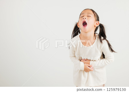 Portrait of Asian young kid girl has stomachache, kindergarten child abdominal pain suffering from stomach ache, studio shot isolated on white background, food poisoning, Health and medical gastritis Portrait of Asian young kid girl has stomachache, kindergarten child abdominal pain suffering from stomach ache, studio shot isolated on white background, food poisoning, Health and medical gastritis 125979130