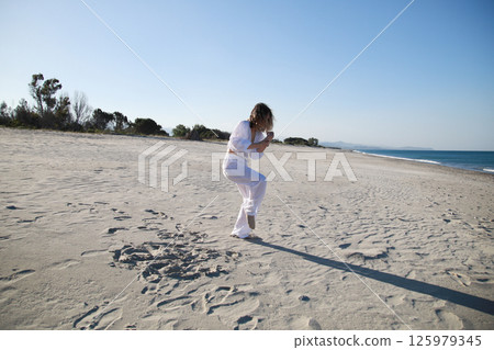 Girl Professional Dances On Calabrian Beach In Summer Vacation Near The Ocean Girl Professional Dances On Calabrian Beach In Summer Vacation Near The Ocean 125979345