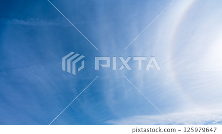 The "Halo Phenomenon" is a mysterious halo of thin clouds and the sun in a clear blue sky. The "Halo Phenomenon" is a mysterious halo of thin clouds and the sun in a clear blue sky. 125979647