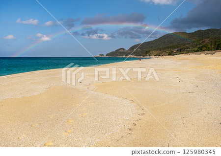 A beautiful rainbow over Nagata Inakahama Beach, a sea turtle nesting site on Yakushima Island (December) 125980345