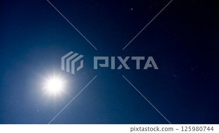 The moonlight illuminating the night sky and countless shining stars 125980744