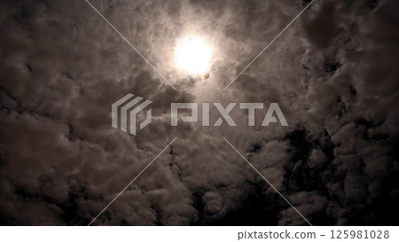 Full moon and starry night sky shining through the clouds Full moon and starry night sky shining through the clouds 125981028