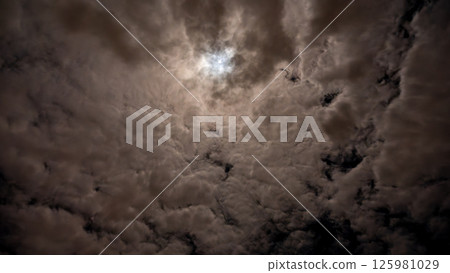 Full moon and starry night sky shining through the clouds Full moon and starry night sky shining through the clouds 125981029