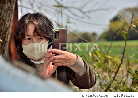 一名女子用手機相機拍照 一名女子用手機相機拍照 125981155