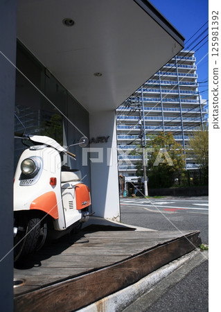 Scooter in front of a hair salon Scooter in front of a hair salon 125981392