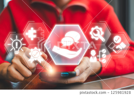 Close-up of hands using a smartphone with digital icons symbolizing advice, communication, and innovation in a modern context. 125981928