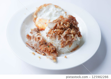 stir fried pork with garlic , pork and rice or deep fried pork or fried pork with rice and sunny side up egg or fried egg 125982266