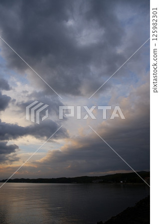 Spring sea covered with thick clouds Spring sea covered with thick clouds 125982301