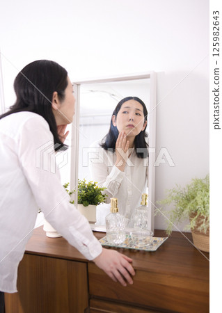 Middle-aged woman suffering from fine lines and age spots 125982643