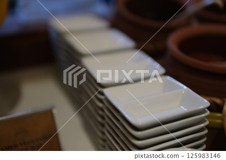 Stacked white dishes on seamless white background. 125983146