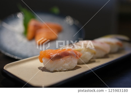 Maki Sushi Rolls on bamboo board isolated on White background with clipping path 125983180