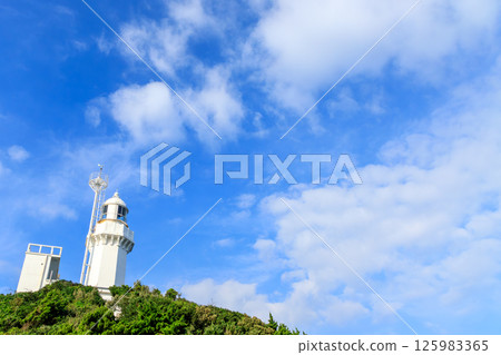 Sadamisaki Lighthouse, the westernmost point of Shikoku, stretches out into the blue sky Sadamisaki Lighthouse, the westernmost point of Shikoku, stretches out into the blue sky 125983365