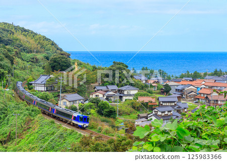 Photographing the townscape of Nagawase and the San'in Main Line from a hilltop overlooking the deep blue Sea of Japan Photographing the townscape of Nagawase and the San'in Main Line from a hilltop overlooking the deep blue Sea of Japan 125983366