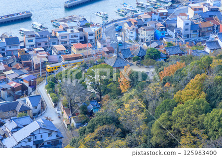 The yellow train runs between the Onomichi Strait and the old temple. The yellow train runs between the Onomichi Strait and the old temple. 125983400